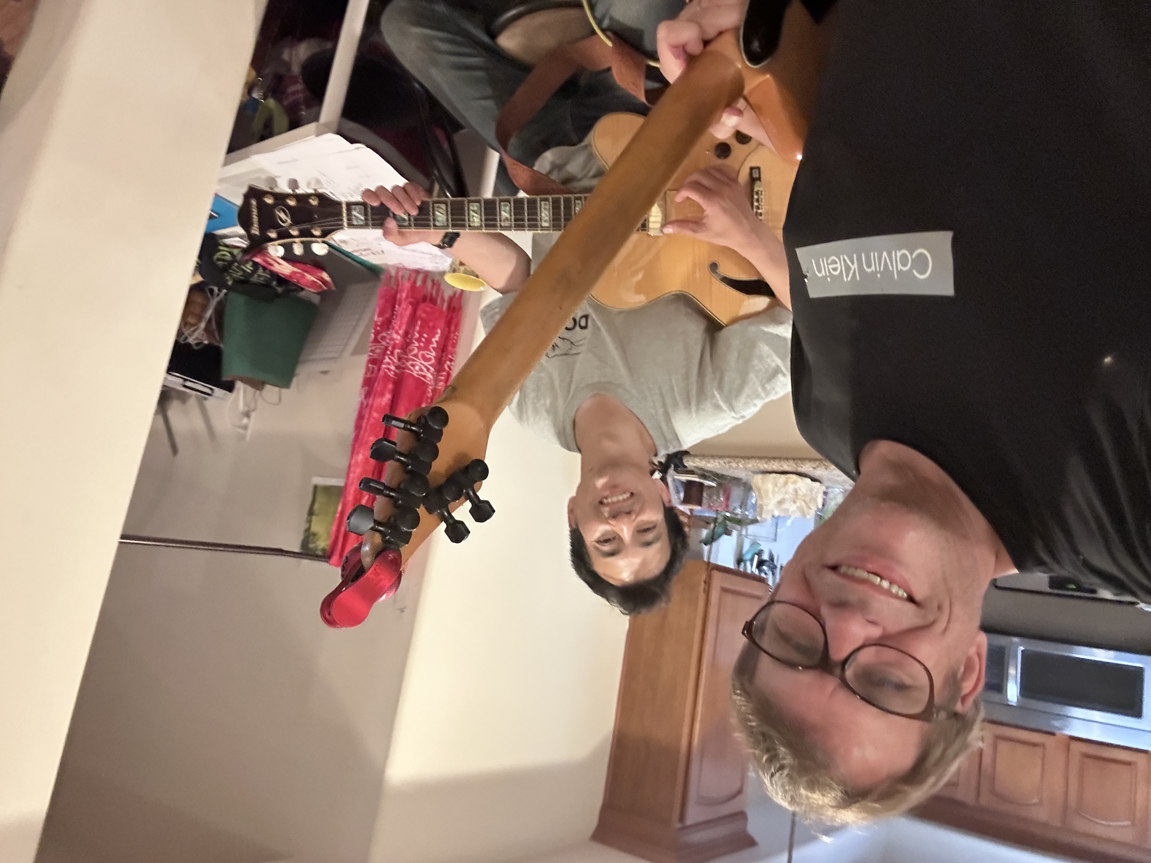 JCollective members rehearsing with a guitar.